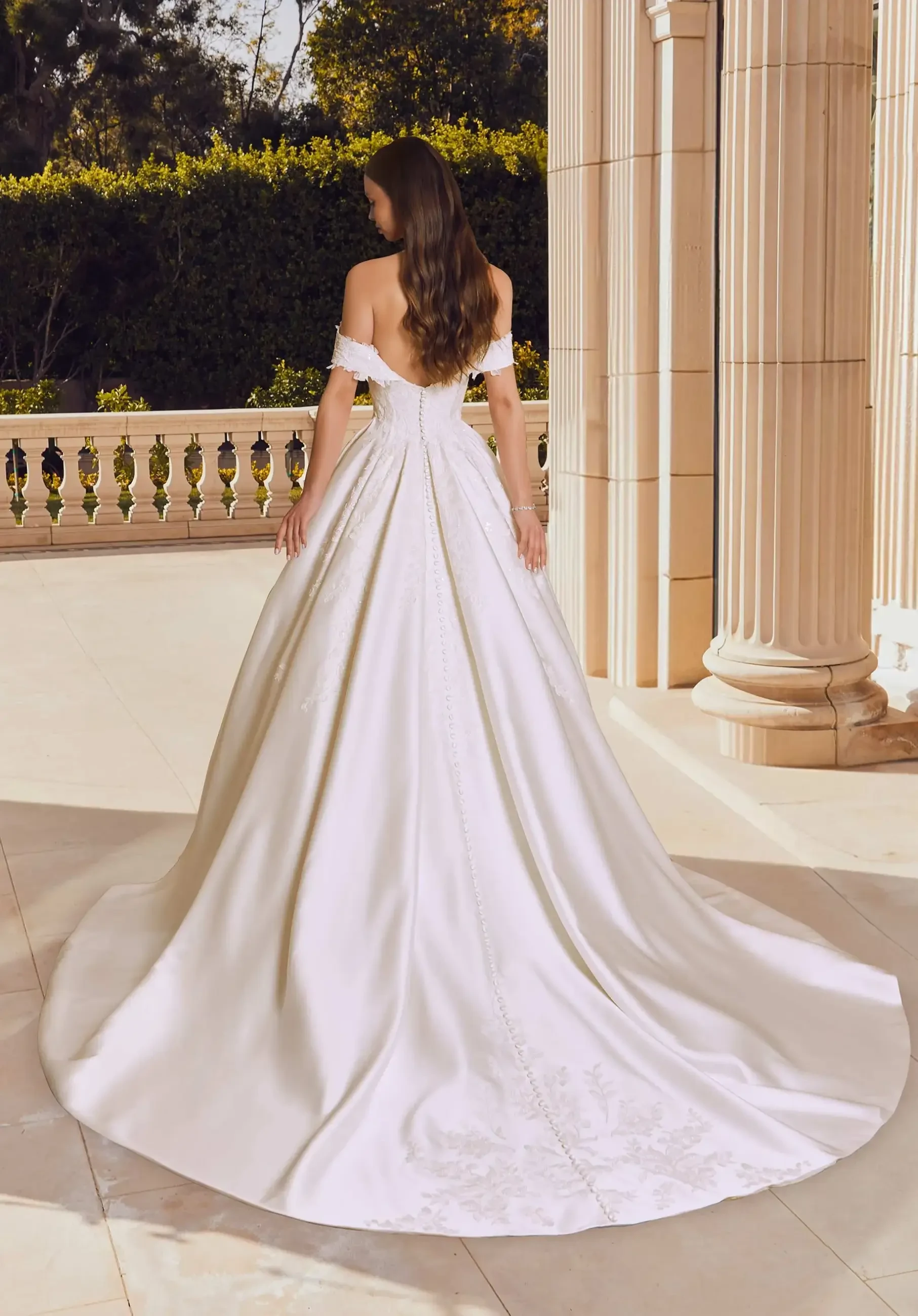 model is wearing a strapless ball gown wedding dress