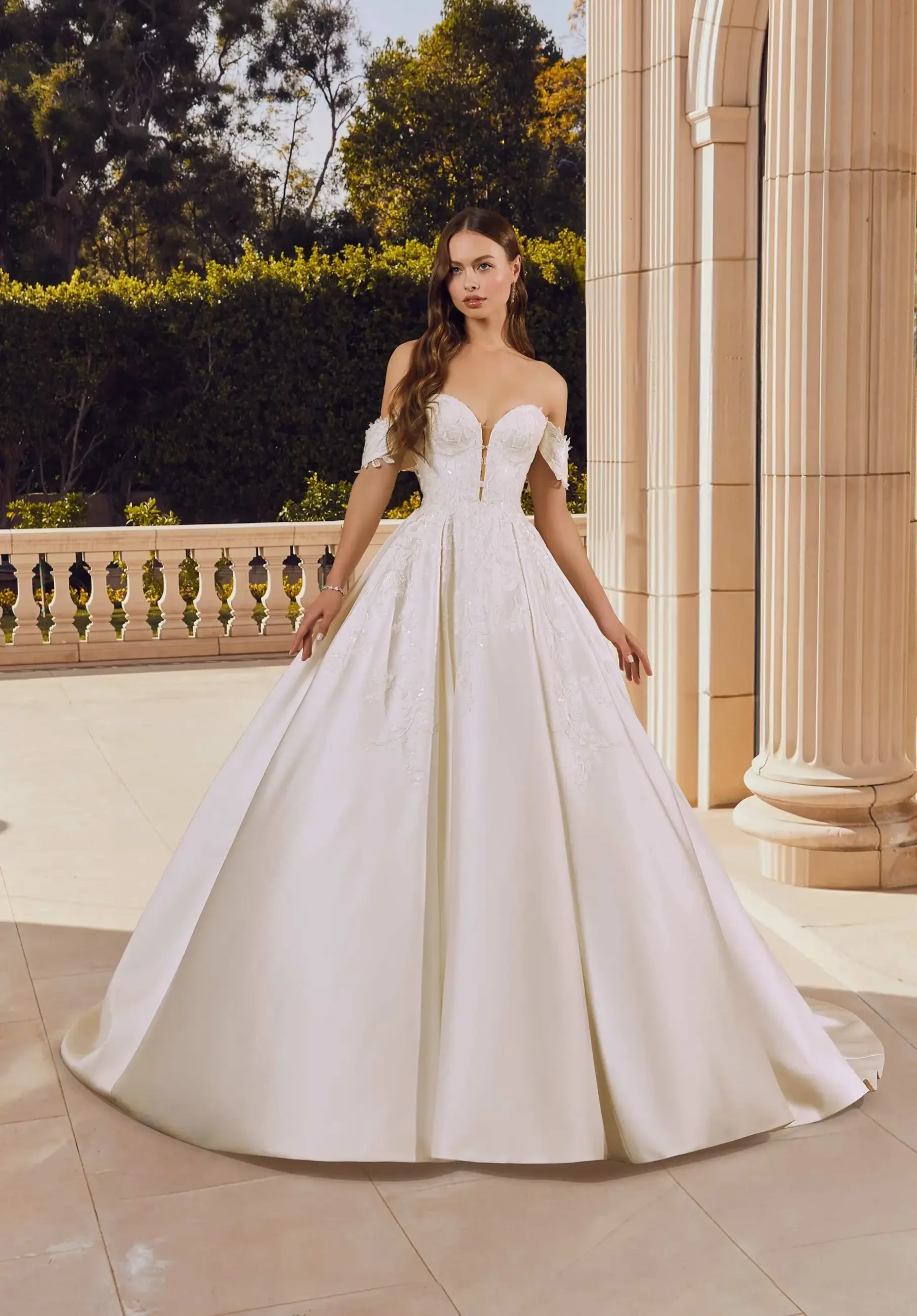 model is wearing a strapless ball gown wedding dress
