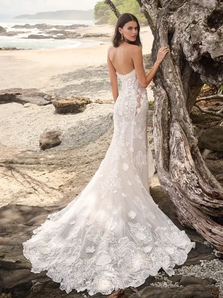 model is wearing a strapless lace fit and flare bridal gown