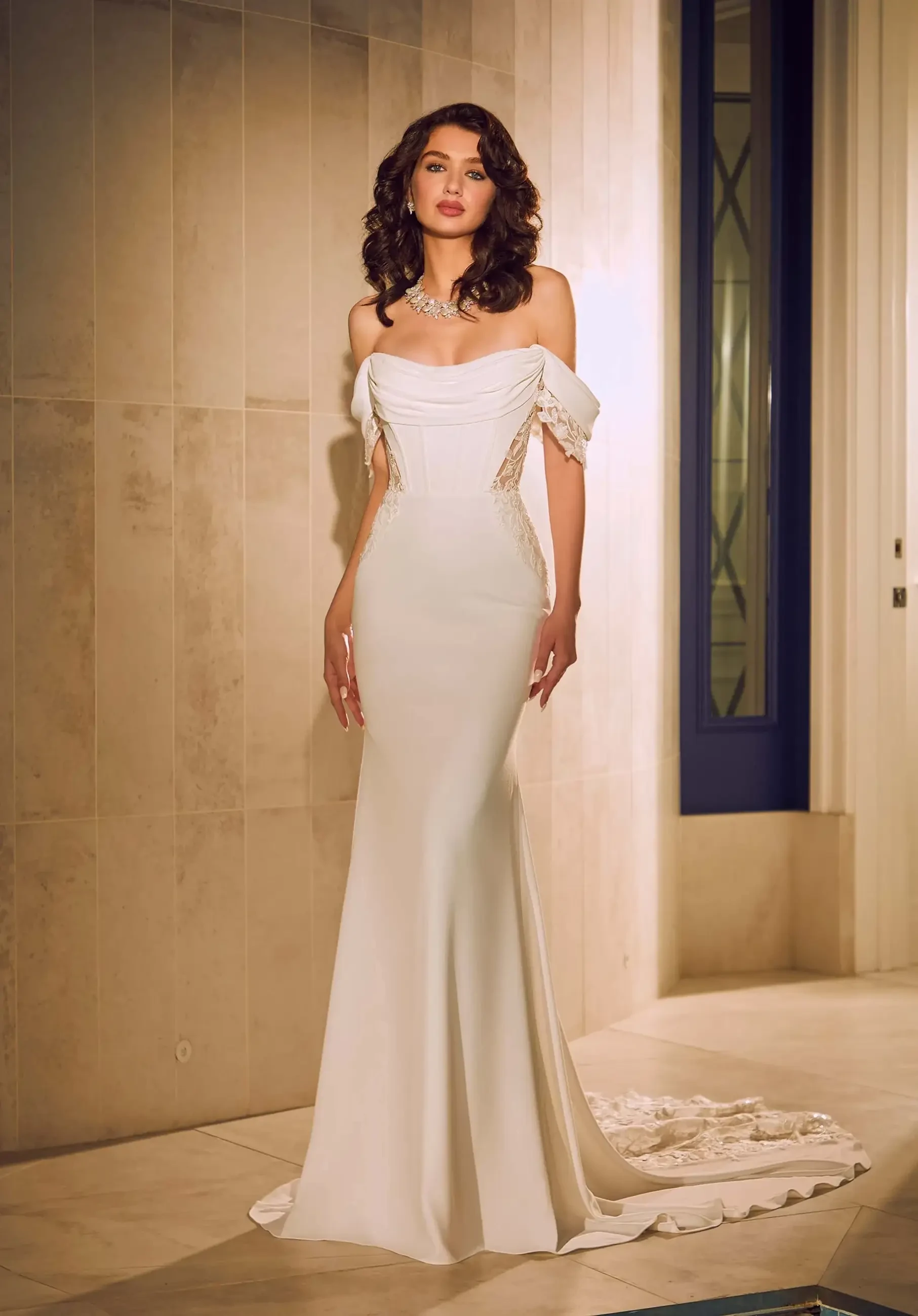 model is wearing an off the shoulder fit and flare wedding dress