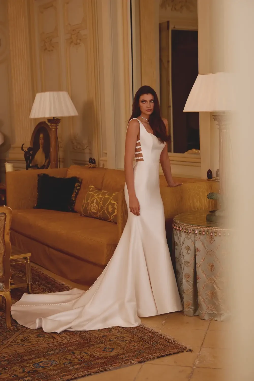 model is wearing an open back bridal gown
