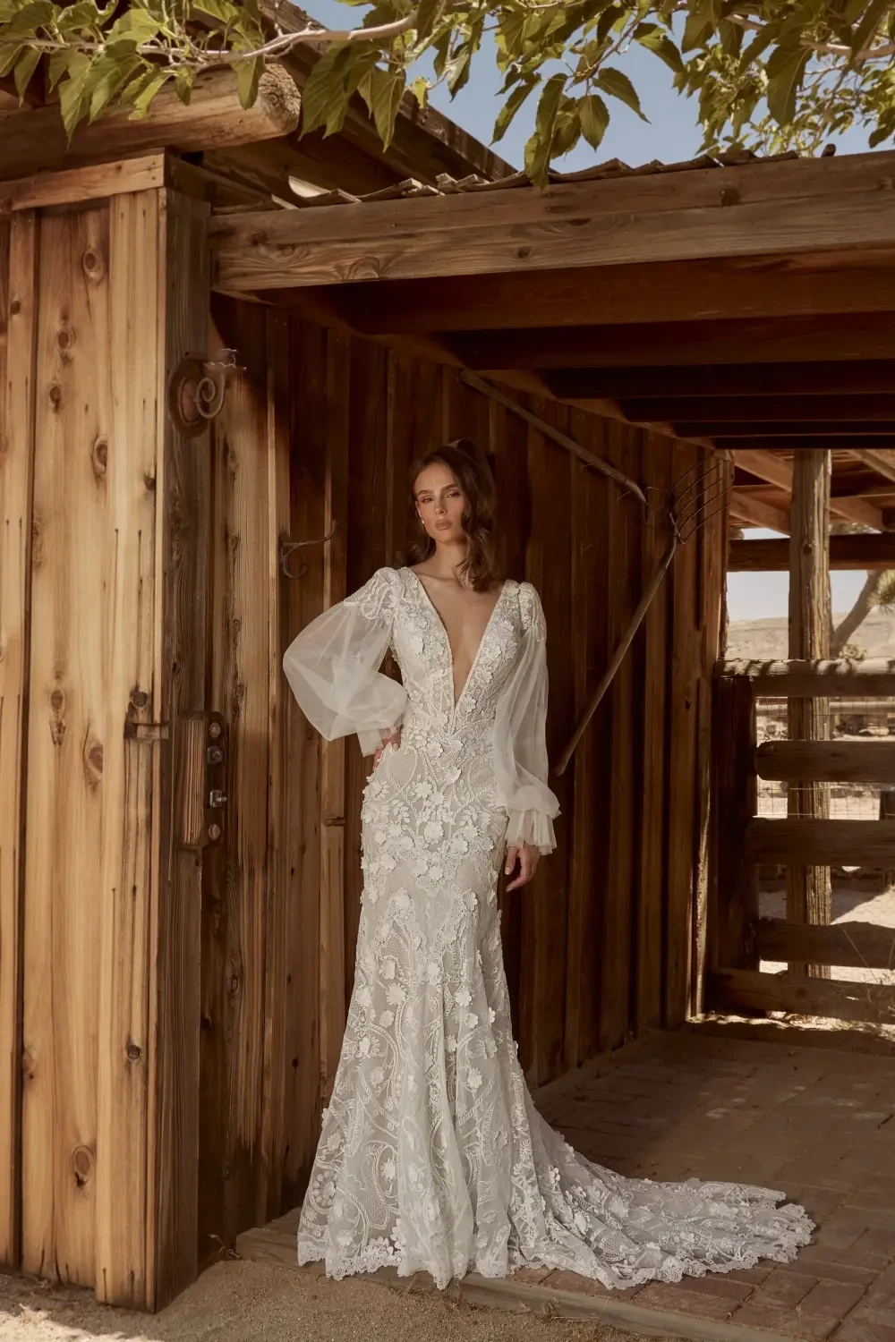 model is wearing a long sleeve bridal gown