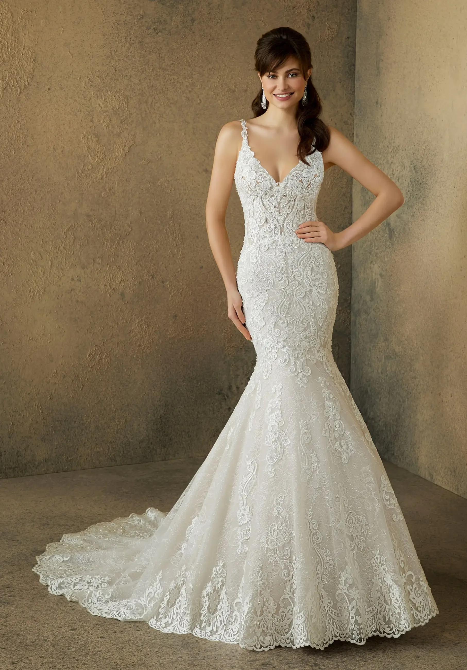 model is wearing a sleeveless mermaid wedding gown